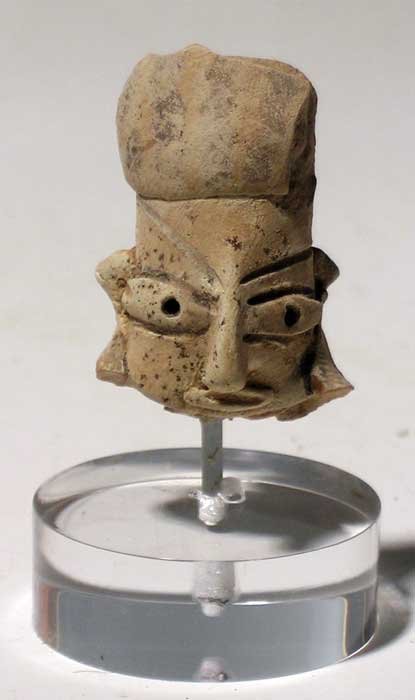 Rare Mohenjo-Daro head fragment from Sindh: A rare Mohenjo-Daro head fragment from Sindh, Indus Valley, c. 2600 - 1900 BC. It is 1-1/2" high and is beautifully detailed with the characteristic eyes and wrapped head. Mounted on stand. Ex Birch e