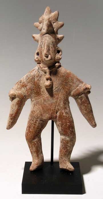 Colima shaman figure from West Mexico: An exceptional Colima shaman figure from West Mexico, c. 300 BC - 300 AD. He is 7-1/2" tall, is posed standing and is wearing a complex headdress with horn. He is adorned with a fancy necklace, ear an