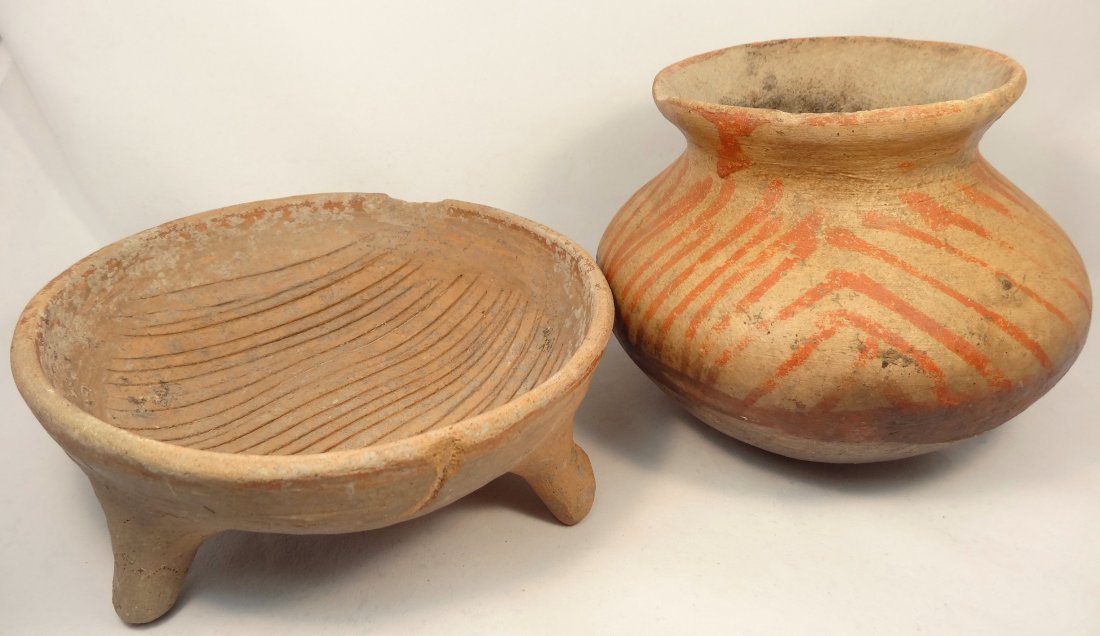 2 pre-Colombian pottery pieces: A lot of 2 Pre-Colombian pottery pieces. The first is a Pre-Columbian jar with rounded bottom and red-orange decoration around the shoulder. H: 5 1/4 in (13.3 cm). Small hole at side and minor rim chi