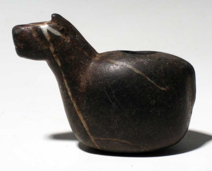A choice Inca canopa from Peru, c. 1300 – 1500 AD: A choice Inca canopa from Peru, c. 1300 – 1500 AD. This beautiful example is 3-1/4” long, is carved from a black stone striated with white quartz and depicts a llama. The head is finely detailed a