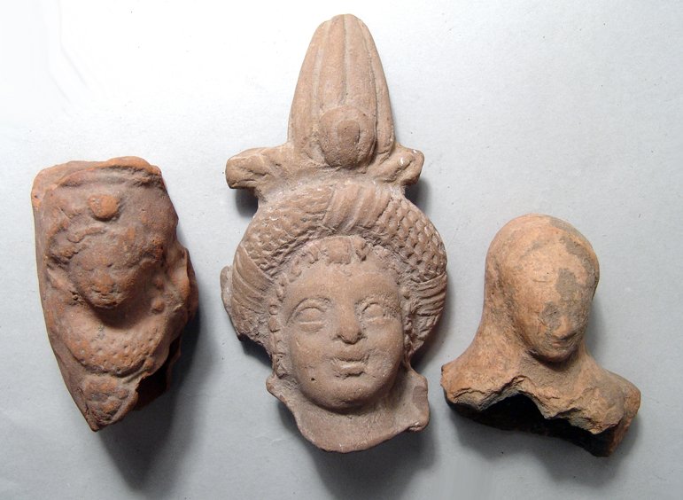 A group of 3 Egyptian terracotta heads: A group of 3 Egyptian terracotta heads, Graeco-Roman Period. Lot includes a detailed head of Harpokrates in fine style, Ptolemaic Greek, c. 3rd - 2nd Century BC, wearing a rolled diadem and solar head