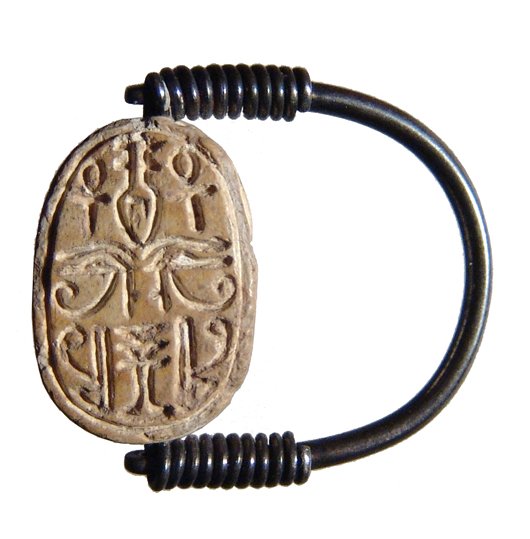 A choice Egyptian steatite scarab: A choice Egyptian steatite scarab, late Middle Kingdom, c. 17th Century BC, the body beautifully carved with detailed legs. On base, symmetric signs including Eyes of Horus, Ankhs, red crowns, a nefer