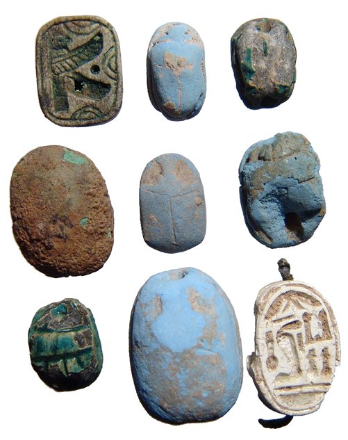 A lot of 7 Egyptian scarabs: A lot of 7 Egyptian scarabs. Lot includes five New Kingdom examples, c. 1570 - 1075 BC, four in faience and one in steatite, the other two Late Period types in glazed steatite. Largest scarab 19 x 14