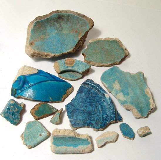 A lot of 14 Egyptian faience fragments: A lot of 14 Egyptian faience fragments, Graeco-Roman, 3rd Century BC/AD, mostly from vessels or offering dishes. Largest 5" (12.4 cm) in length. Ex Dudley Short collection, UK, acquired in the 1920's.
