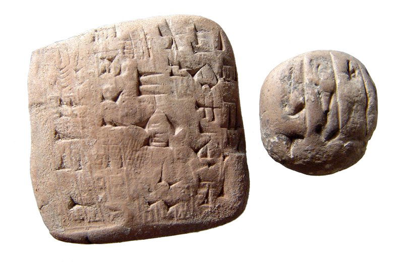 A pair of Near East cuneiform tablets: A pair of Near East cuneiform tablets. Lot includes an Old Babylonian tablet, c. 1900 - 1750 BC, with nicely incised text and cylinder seal impressions, (4 x 3.9 cm). The second is an Old Akkadian tab