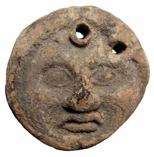 A Greek terracotta loom weight with Gorgon head: A Greek terracotta loom weight with Gorgon head, c. 5th - 4th Century BC, two holes for suspension. A nice example with some earthen encrustation. Dia: 3" (7.6 cm). Ex Henk Huffener collection, UK, ac