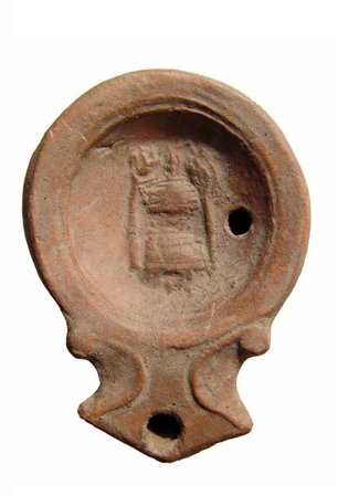 Roman Terracotta discus lamp with altar flanked by: A Roman Terracotta discus lamp with altar flanked by torches, 1st Century AD, the central disk featuring a tiered altar flanked by torches. The shoulder is flat and narrow, the arrowheaded nozzle with