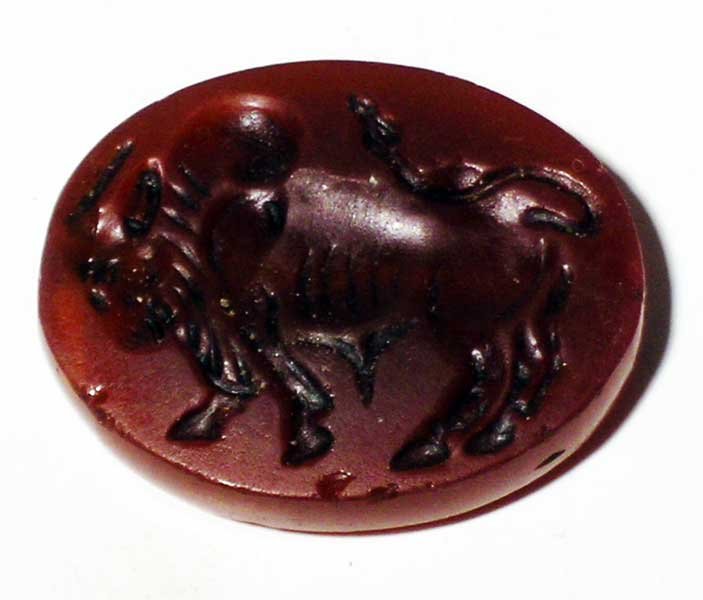 A choice Sasanian seal, c. 224 - 651 AD: A choice Sasanian seal, c. 224 - 651 AD. It is 1-1/4" in wide and depicts a superbly detailed bull. Carved from beautiful translucent carnelian and perforated laterally for suspension. Expected wear a