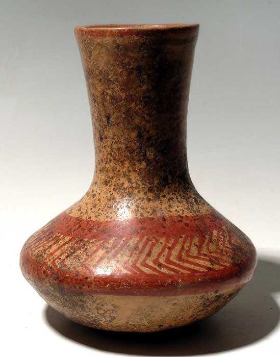 A rare flared spout vase from the Valley of Toluca,: A rare flared spout vase from the Valley of Toluca, Mexico, c. 300 - 100 BC. This exceptional Tlatotepec vessel is 7" high and is decorated with characteristic red-on-buff resist designs on the upper 