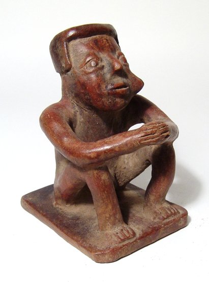 Narino male seated "Coquero", Colombia, Capuli Complex: An attractive Narino male seated "Coquero", Colombia, Capuli Complex, AD 850 - 1500, he is depicted nude with genitalia exposed, his legs drawn up and arms resting on knees, hands together, a wad of c