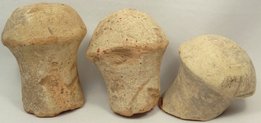 A lot of 3 Roman terracotta amphora stoppers: A lot of 3 Roman terracotta amphora stoppers, each with earthen deposits. Largest measures 3 in (7.6 cm) in length. Ex old English collection.