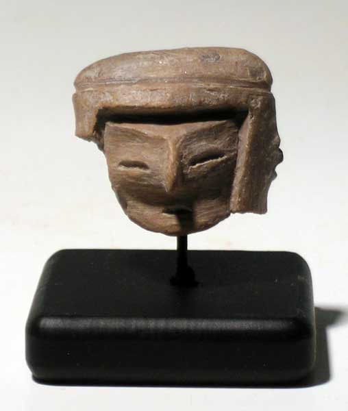 Valdivia head fragment from Ecuador: An excellent Valdivia head fragment from Ecuador, c. 3000 - 2000 BC. This early type is 1 3/8 in (3.5cm) high, 1 1/2 in (3.8cm) wide and depicts an individual with a complex coif or headdress. Wonderf