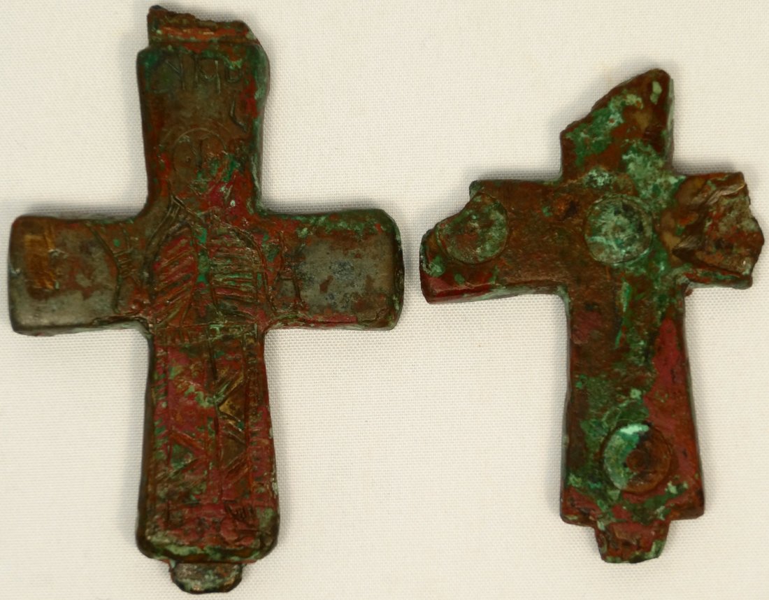 A Byzantine Enkolpia, c. 10-12th Century AD: A Byzantine Enkolpia, c. 10-12th Century AD, in halves, the front piece depicting an image of Jesus. The clasps are mostly lost and there are losses to the back piece. H: 2 2/3 in (6.8cm), W: 1 3/4 in