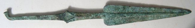 Near Eastern bronze javelin spear head: A nice Near Eastern bronze javelin spear head, c. 1000 - 600 BC, the triangular blade with rounded ends and pronounced midrib, the tapered shaft widening at base and surmounted on a long rait-tailed t