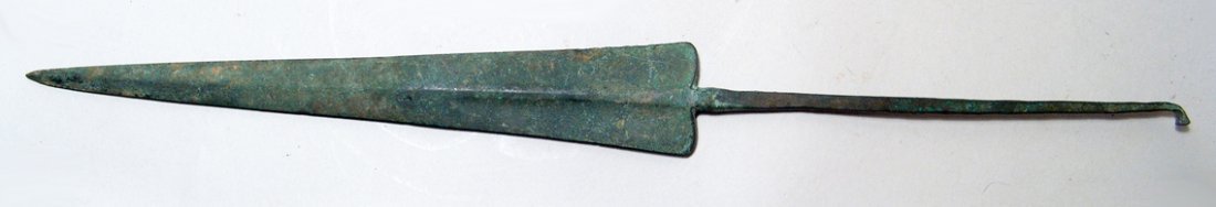 Near Eastern bronze spear head: A long and slender Near Eastern bronze spear head, c. 1200 - 800 BC, the blade triangular with midrib which divided the base which terminate with slightly curved base, very long rat-tail tang. L: 17 1