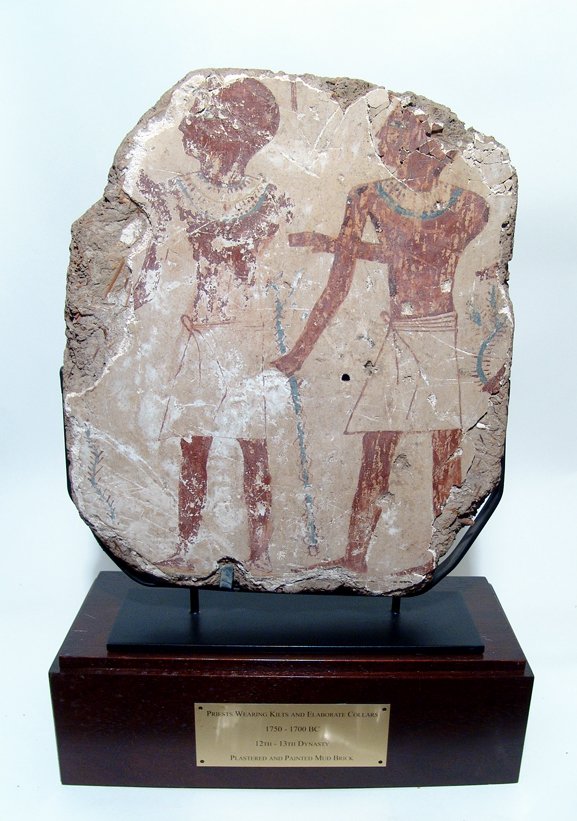 Large Egyptian relief depicting a pair of priests: A large Egyptian relief depicting a pair of priests, Middle Kingdom, 12th - 13th Dynasty, c. 1750 - 1700 BC, each with a staff in their extending right hands. Each priest is bald and wears a kilts and