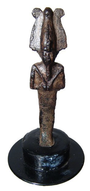 An Egyptian bronze figure of Osiris: An Egyptian bronze figure of Osiris, Late Period, c. 664 - 343 BC, mummiform, wearing Atef crown with uraeus and false beard, arms at chest, hands together holding a crook and flail. Intact, repaired 