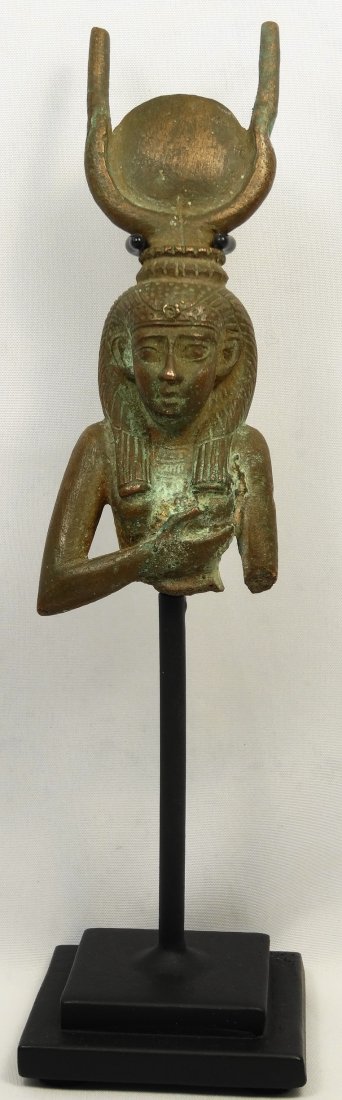 Egyptian partial bust from a statue of Isis: A beautiful Egyptian partial bronze bust from a seated statue of Isis, Late Dynastic period, c. 600 BC. Isis with her hand to her breast, on her head a crown with a base of Uraei topped with bull horn