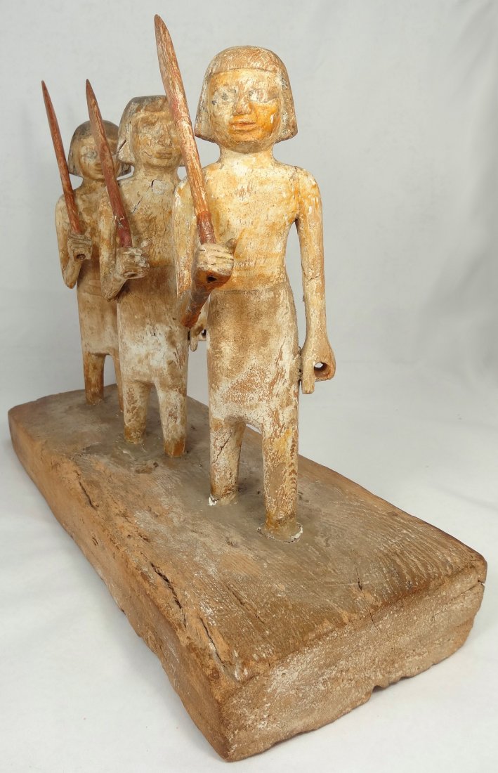 Egyptian tomb representation of three oarsmen: A magnificent and completely intact New Kingdom, c. 1570 - 1075 BC, Egyptian wooden tomb representation of three oarsmen walking in line, L: 14 1/3 in (36cm), H: 10 2/3 in (27cm), facing left and carr