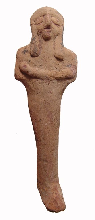 A large Egyptian terracotta ushabti: A large Egyptian terracotta ushabti, Late New Kingdom, c. 1292 - 1075 BC, mummiform, wearing tripartite wig, arms folded across chest, long pointed foot. The implements held in the hands were original