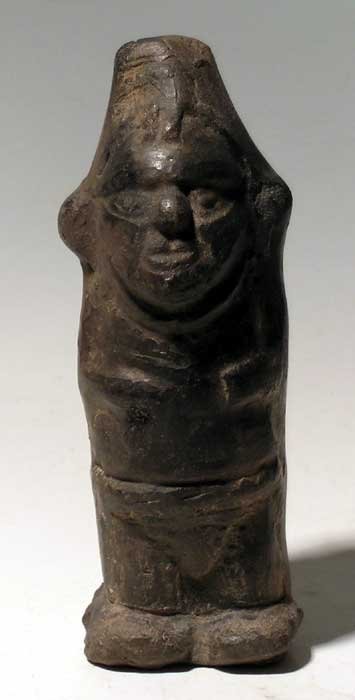 Beautifully detailed Lambayeque (Sican) figure: A beautifully detailed Lambayeque (Sican) figure from Peru, c. 700 – 1300 AD. It is 5-3/4” high and depicts a trader carrying a bag on his back. He is wearing a mantle and ornate clothing and is a