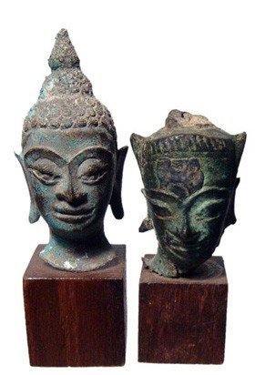 A lot of 2 bronze heads of Buddha, Thailand: A lot of 2 bronze heads of Buddha, Thailand, 16th - 18th Century. A mix of styles and all with nice patinas. One with losses to flame at top of ushnisha. Heights from 2 ½ in (3.8 cm) to 2 1/8 in (5.4