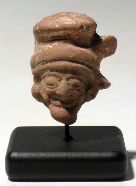 Vera Cruz head fragment from Mexico: A choice Vera Cruz head fragment from Mexico, c. 300 – 900 AD. This beautifully sculpted piece is 2 in (5.1cm) high and depicts one of the Old Gods. He is wearing a fancy headdress and is adorned wi