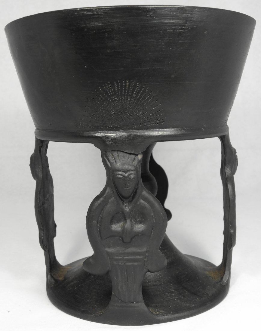 Shallow Etruscan Bucchero chalice: A shallow Etruscan Bucchero chalice, c. 625 - 550 BC, with central bowl, the outside of which decorated with four fan designs, and the pedestal plain with wide foot, H: 6 7/8 in (17.5cm). Added in res