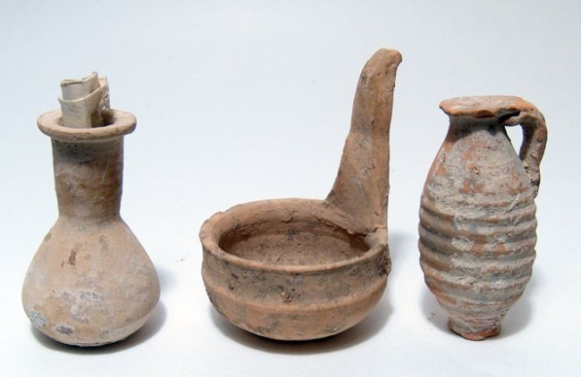 Lot of 3 ancient pottery items: A lot of 3 ancient pottery items. The first is a small Greek terracotta vial, c. 3rd - 2nd Century BC, H: 2 1/2 in (6.3 cm); the second a terracotta ladle from the same period, H: 3 1/8 in (7.9 cm); a