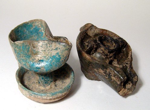 A pair of Islamic glazed lamps: A pair of Islamic glazed lamps. The first is a Nishapur turquoise glazed lamp with cop base, c. 12th Century, the color nice with some areas of glaze degradation. H: 3 ½ in (8.8 cm). The second is an