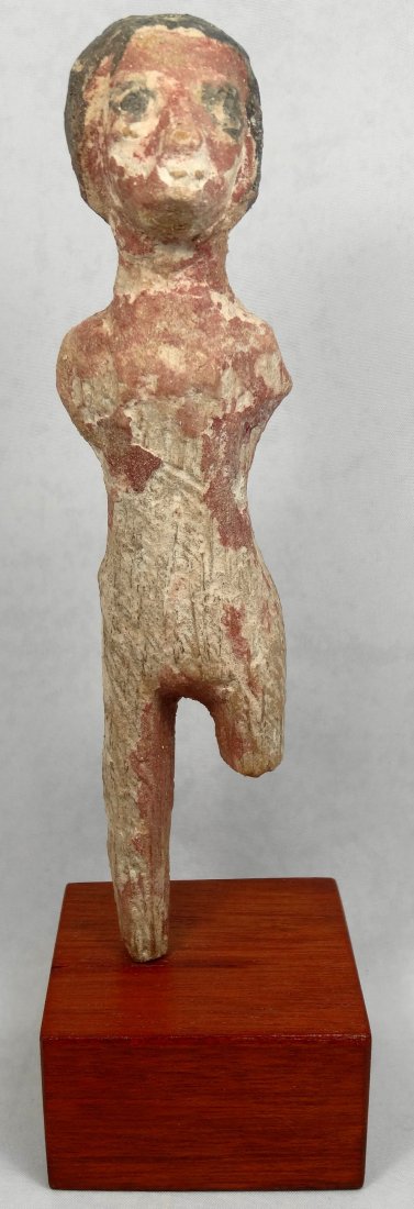 Egyptian carved wood figure of a male: An Egyptian carved palm wood and gesso polychrome figure of a male, c. Middle Kingdom, 2134-1690, likely a herdsman or farmer from a larger scene, H: 6 ¼ in (15.8cm). On a custom wooden base, with co