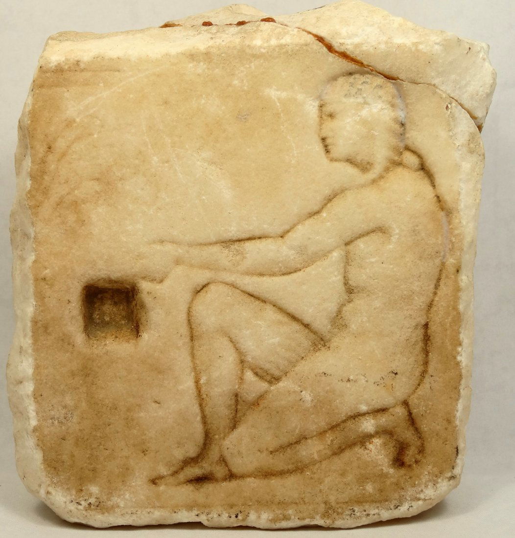 Romano-Egyptian limestone stele: A Romano-Egyptian limestone stele, c. 1st Century BC-3rd Century AD, depicting a kneeling man reaching out with his left hand, H: 5 1/10 in (13cm), W: 4 2/5 in (11.2cm). The man is wearing an Egyptian