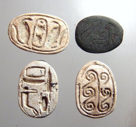A lot of 4 Egyptian scarabs: A lot of 4 Egyptian scarabs. Lot includes a pair of New Kingdom steatite examples, one with a cartouche of Thutmose III, (18 x 12mm), and the other with a blessing reading “establish they name with 