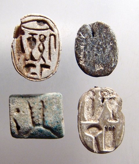 A lot of Egyptian scarabs and a scaraboid: A lot of Egyptian scarabs and a scaraboid. Lot includes a New Kingdom faience plaque, c. 1570 - 1075 BC, with Eye of Horus, (15 x 12mm), a pair of New Kingdom steatite scarabs with neatly incised hier