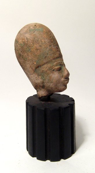 Egyptian terracotta head of a god or pharaoh: An Egyptian terracotta head of a god or pharaoh, Late Period, c. 664 - 30, wearing what appears to be a Khepresh, or war crown, the facial details nicely molded and traces of original turquoise glaze 