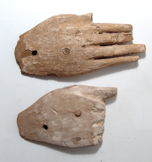 Pair of wooden hands, each from anthropoid coffin: A Pair of wooden hands, each from an anthropoid coffin. One example has extended fingers and is from the late New Kingdom - 3rd Intermediate Period, c. 1292 - 945 BC, with traces of deep yellow paint,
