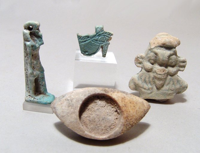 3 Egyptian amulets and an alabaster eye inla: A lot of 3 Egyptian amulets and an alabaster eye inlay. Lot includes three light blue faience amulets - a Wedjat or 'Eye of Horus' amulet mounted on a lucite base, (21 x 20mm), an amulet of the god Th