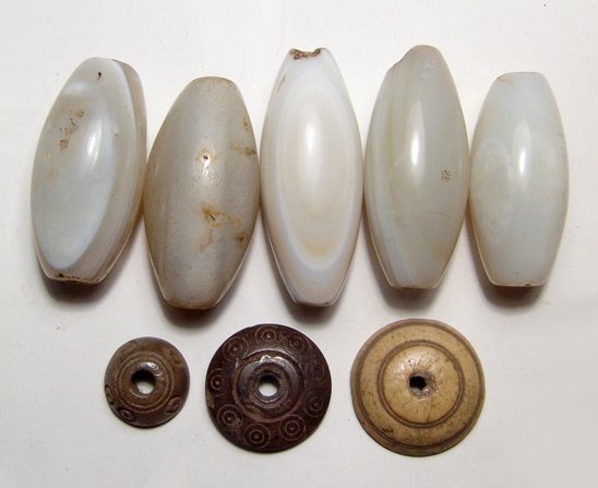 6 Near Eastern chalcedony beads and 3 Roman Spindle: A lot of 6 Near Eastern chalcedony beads and 3 Roman Spindle Whorls. Lot includes six banded chalcedony beads, c. 1st Millennium BC, tapered at each end and drill lengthwise for suspension, (Largest 5