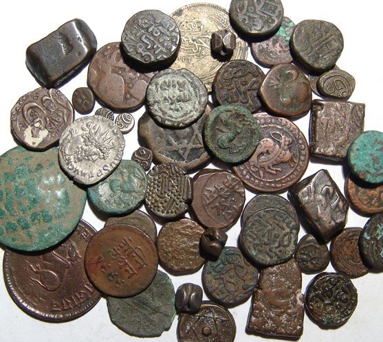 A mixed lot of coins from Central, India and Asia: A mixed lot of coins from Central, India and Asia, mostly in bronze but some in silver. Also includes a pair of Greek coins of Philip II of Macedon, a Roman silver coin of Postumus, as well as many ot