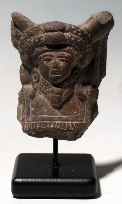 Vera Cruz figural fragment from Mexico: An excellent Vera Cruz figural fragment from Mexico, c.300 - 900 AD. It is 3 in high and depicts a priest attired in extensive ceremonial regalia. He is wearing a large, complex headdress, multiple ne