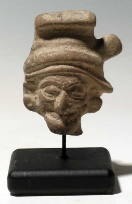 Vera Cruz head fragment from Mexico: A choice Vera Cruz head fragment from Mexico, c. 300 - 900 AD. This beautifully sculpted piece is 2-3/8 in high and depicts one of the Old Gods. He is wearing a fancy headdress and is adorned with ear