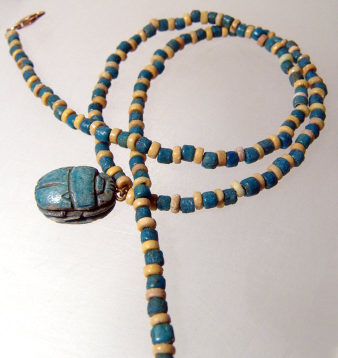 A nice Egyptian faience bead necklace: A nice Egyptian faience bead necklace, 3rd Intermediate - Late Period, c. 1075 - 343 BC, with high quality yellow and blue beads with vibrant color. Nicely strung on modern cord and clasp with a moder