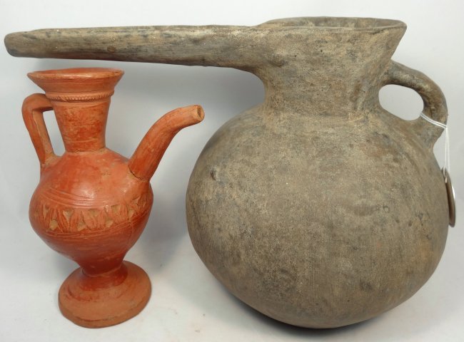 A lot of 2 spouted vessels: A lot of 2 spouted vessels. The first is a black-ware Amlash terracotta vessel, c. 1400 - 1200 BC, with beaked spout. Heavily restored but attractive. The second vessel is a possibly ancient, odd red-