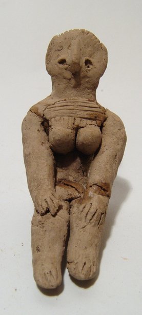 A Central Asian terracotta fertility figure: A Central Asian terracotta fertility figure, c. 3rd Millennium BC, depicted nude with hands on her knees, large breasts and wearing a necklace, her features stylized with large nose. H: 2 2/3 in (6.7c