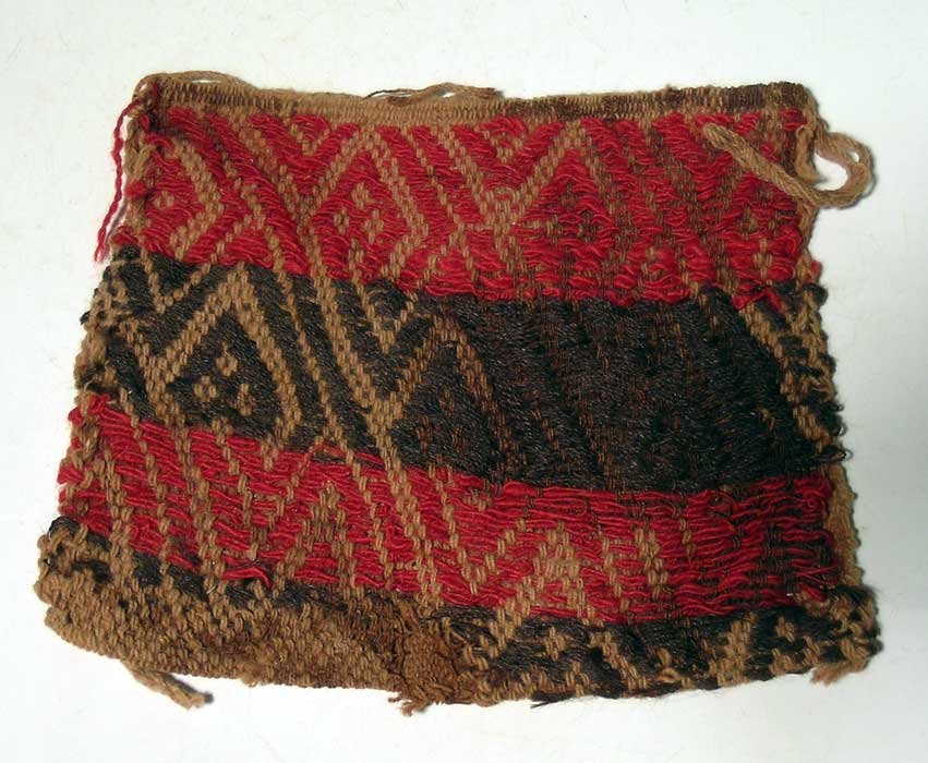 Excellent Chancay coca bag from Peru: An excellent Chancay coca bag from Peru, c. 1100 – 1450 AD. It is 6 in wide, 5 in high and features a colorful interwoven serpent pattern. A beautiful example with some burial stains. Ex Gallatin es