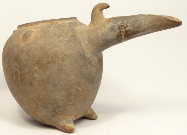 Near Eastern terracotta pouring vessel: A Near Eastern, long spouted terracotta pouring vessel, c. 1300-1000 BC, in the form of stylized animal, likely a bird, H: 3 7/8 in (9.8cm), L: 5 2/3 in (14.5cm). Ex New York Private Collection.