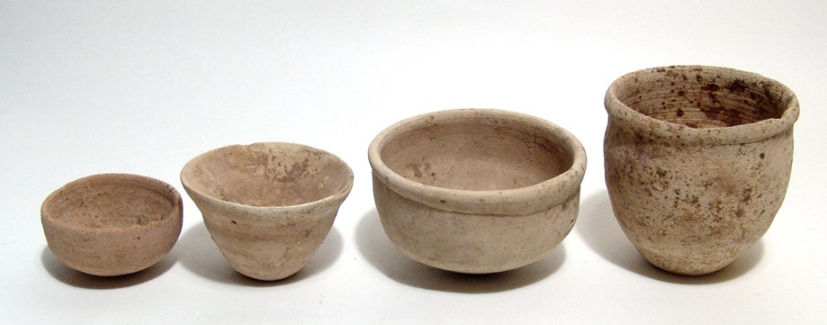 A group of Early Bronze Age ceramic vessels: A group of Early Bronze Age ceramic vessels from the Holy Land, c. 3100 - 2800 BC, including a deep bowl, a pair of offer bowls and a beaker. Deep Bowl: H: 2 3/8 in (6 cm); Dia: 4 in (10.1 cm). Offeri