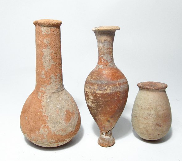 A lot of 3 Roman ceramic vessels: A lot of 3 Roman ceramic vessels, c. 1st - 2nd Century AD, including an unguentarium, (5 5/8 in, 14.3 cm), a spindle bottle, (5 3/8 in, 13.7 cm), with red-orange slip and some white banding around the