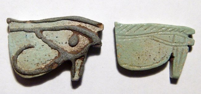 Lot of 2 Egyptian 'Eye of Horus' Amulets: Lot of 2 Egyptian 'Eye of Horus' Amulets. One a Bicolor Amulet from the 3rd Intermediate Period, L: 1 1/8 in (2.9cm). The other, L: 1 in (2.4cm). Ex Collection of Elennore de Mot, acquired in the earl