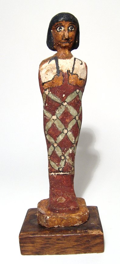 Egyptian painted wood ushabti-type figure: An attractive Egyptian painted wood ushabti-type figure, Late Period, c. 664 - 30 BC, depicted mummiform, wearing short wig, arms folded at chest, hands holding a crook and flail, beaded net down the 